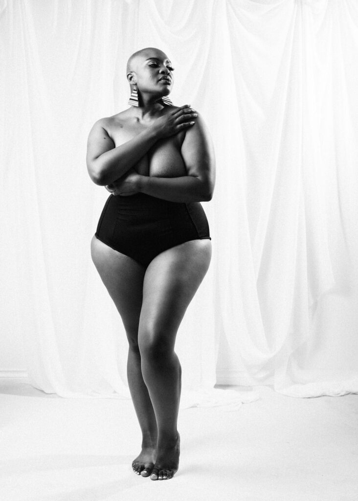 Plus size boudoir photoshoot of Black woman with alopecia