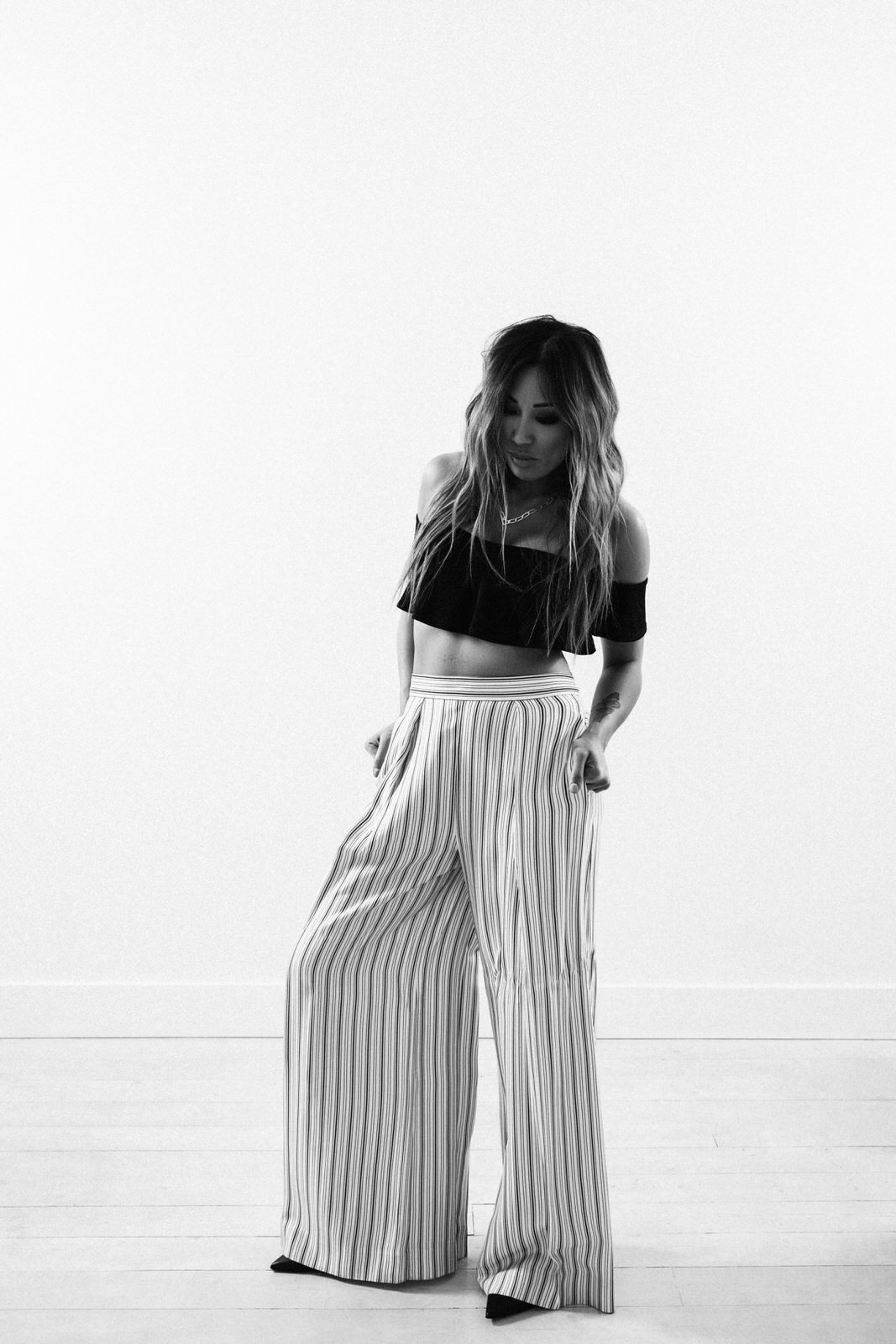 vancouver intimate portraits of woman standing in striped pants and dark off shoulder crop top