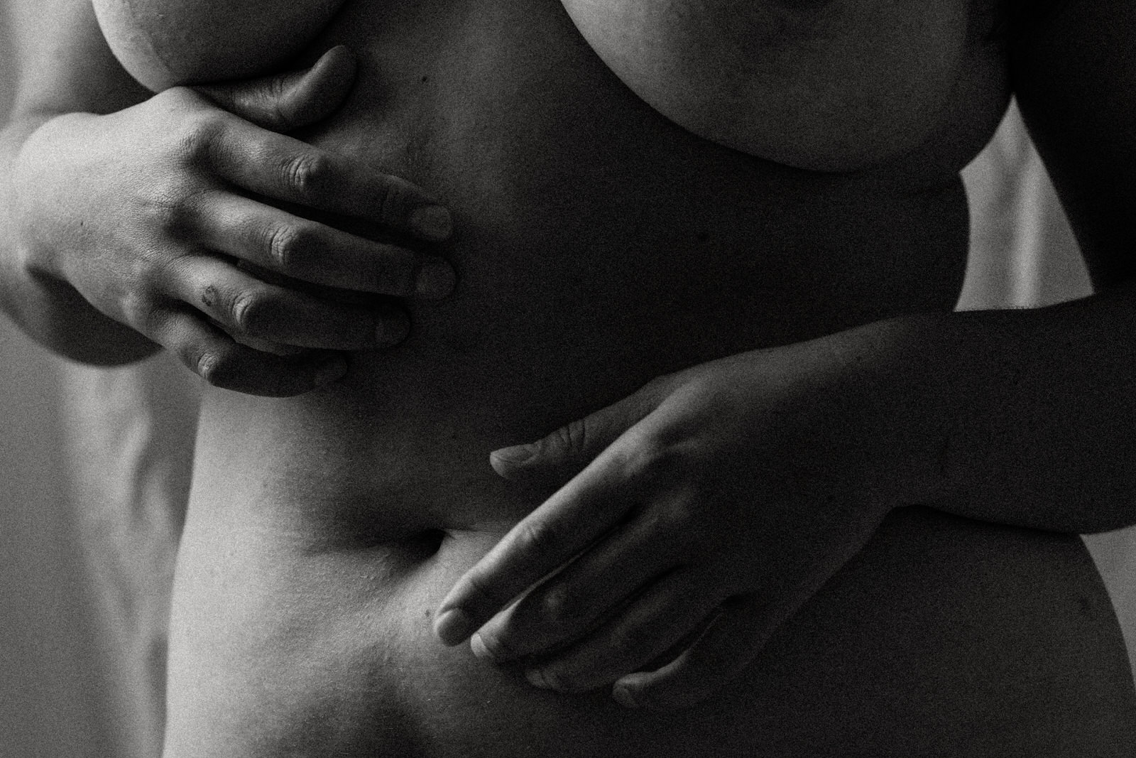 fine art nude boudoir image of a woman holding her stomach
