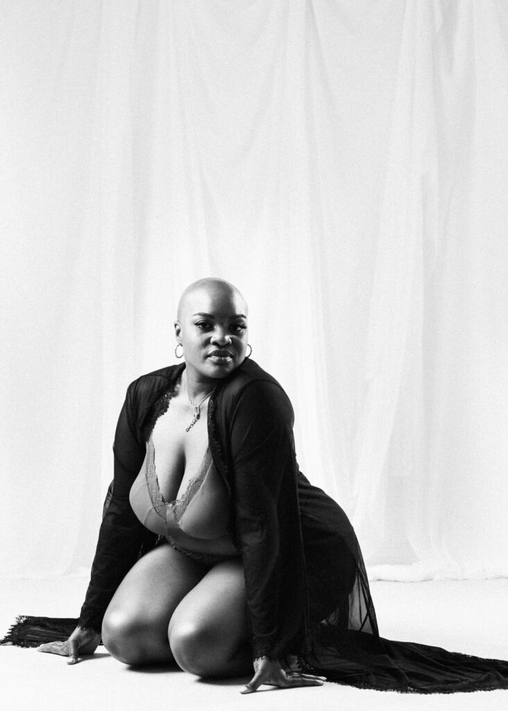 vancouver boudoir photographer image of plus size black woman with alopecia wearing lingerie and kneeling