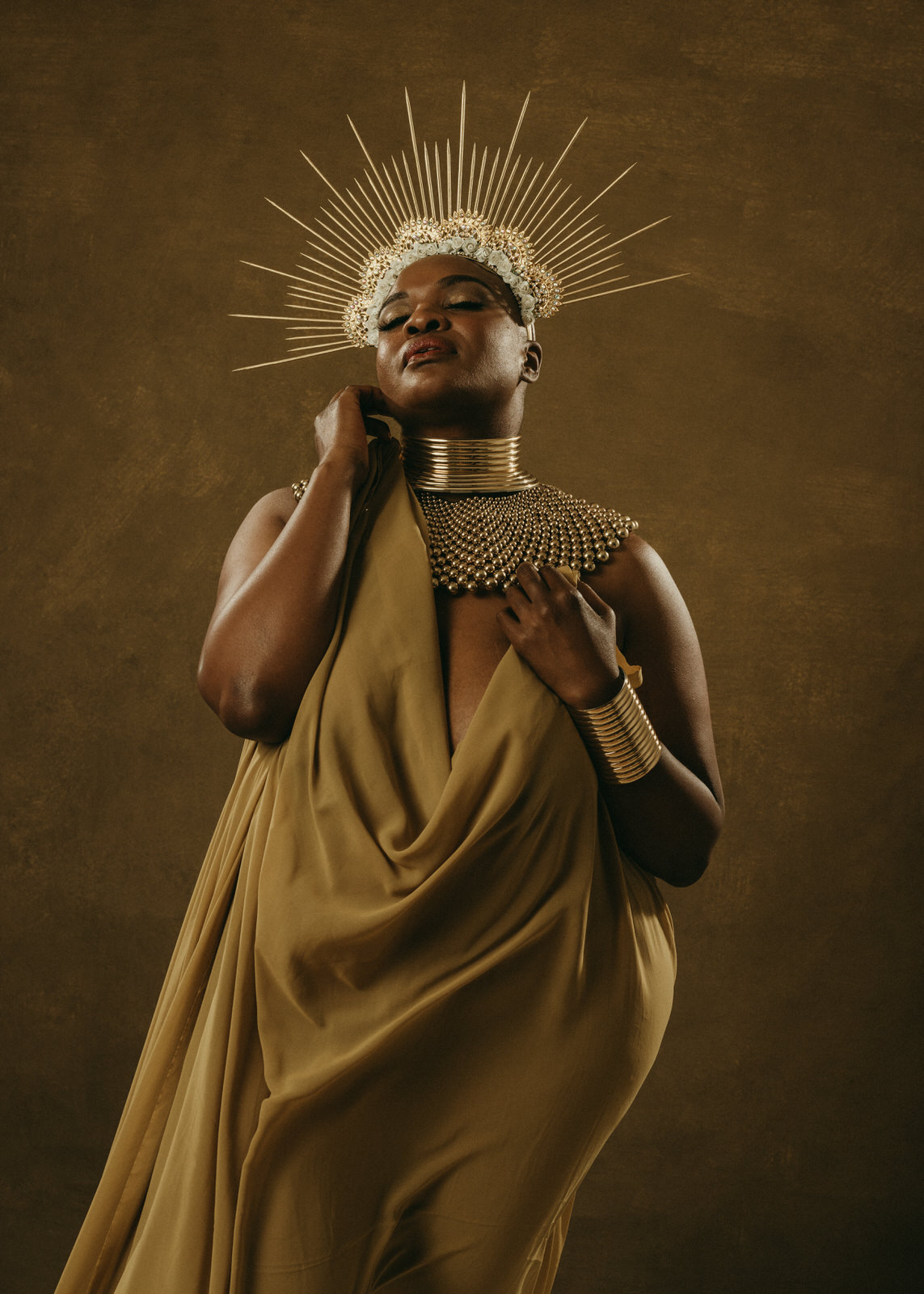 vancouver boudoir photographer image of plus size black woman with alopecia wearing gold fabric and sun crown