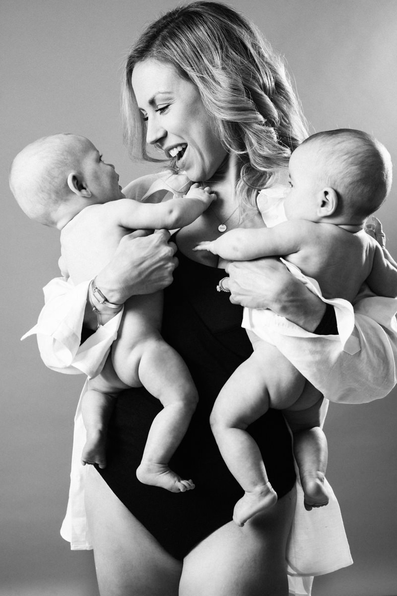 family portrait of mom with twin newborns